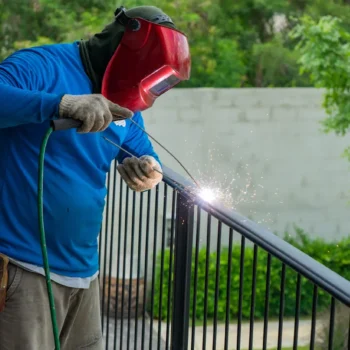 welder-with-safety-mask-welding-the-steel-fence-wi-2022-11-01-00-01-53-utc-scaled